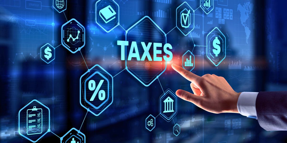 A hand touching a digital screen featuring a glowing blue interface with "TAXES" text and financial icons.