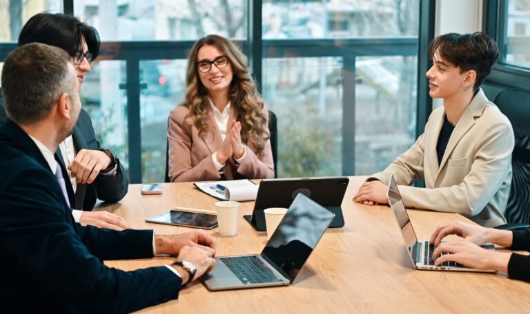 A team consulting a tax consultant in dubai during a financial review meeting in a modern office