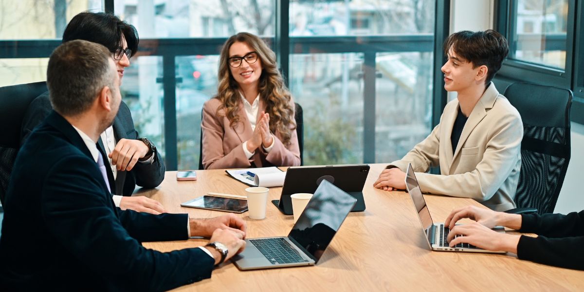 A team consulting a tax consultant in dubai during a financial review meeting in a modern office