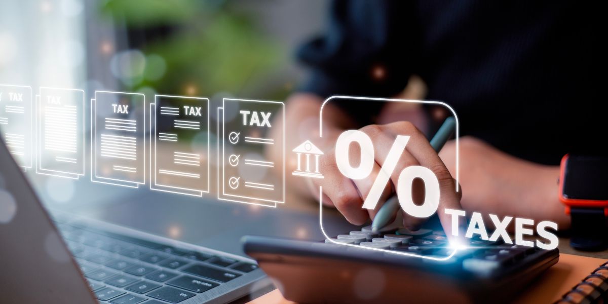 A professional tax consultant in dubai using a calculator and digital icons to process complex tax regulations.