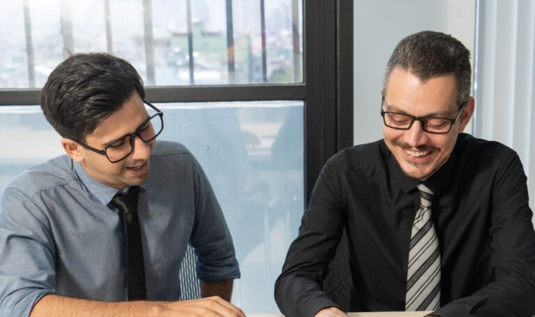 Businessmen consulting a tax consultant in dubai to discuss the key differences between VAT and corporate tax.